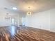 Spacious living room with hardwood floors and modern light fixtures at 124 Meridian Ave, Kissimmee, FL 34759