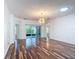 Bright living room featuring wood floors, a modern light fixture, and sliding glass doors to the outside at 124 Meridian Ave, Kissimmee, FL 34759