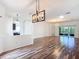 Spacious living room featuring hardwood floors, recessed lighting, and access to the kitchen at 124 Meridian Ave, Kissimmee, FL 34759