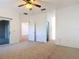 Carpeted main bedroom with ceiling fan, sliding glass doors to the outside and access to the bathroom at 124 Meridian Ave, Kissimmee, FL 34759