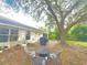 Enjoy outdoor entertaining with a patio, fire pit and plenty of seating in this backyard at 13440 Fordwell Dr, Orlando, FL 32828
