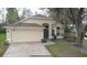Charming single-story home featuring a two-car garage and well-maintained front yard at 13440 Fordwell Dr, Orlando, FL 32828