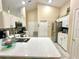 Modern kitchen with white cabinets, stainless steel appliances, and quartz countertops at 13440 Fordwell Dr, Orlando, FL 32828