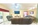 Comfortable living room with a ceiling fan, large windows and a plush couch and a large screen television at 13440 Fordwell Dr, Orlando, FL 32828