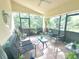 A covered patio provides a relaxing outdoor space with comfortable seating and views of the landscaped yard at 13440 Fordwell Dr, Orlando, FL 32828