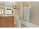 Clean bathroom with a shower-tub combo and a wood vanity cabinet with a sink at 151 Castaway Beach Way, Kissimmee, FL 34746