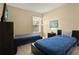 Shared bedroom featuring two twin beds, neutral walls, and modern decor accents at 151 Castaway Beach Way, Kissimmee, FL 34746
