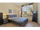 Stylish bedroom with a large window, decorative artwork, and dark furniture accents at 151 Castaway Beach Way, Kissimmee, FL 34746