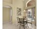 Inviting dining area with high ceilings, a window, and a modern light fixture at 151 Castaway Beach Way, Kissimmee, FL 34746