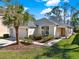 Charming single-story home with a well-manicured lawn, mature landscaping, and an attached two-car garage at 151 Castaway Beach Way, Kissimmee, FL 34746
