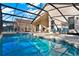 A luxurious screened-in pool area is complemented with ample seating and relaxation space at 151 Castaway Beach Way, Kissimmee, FL 34746