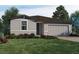 Charming single-story home with a well-manicured lawn and colorful flowerbeds at 1550 Mermaid Way, Haines City, FL 33844
