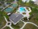 An aerial view showcases the community pool, clubhouse, and basketball courts near the lake at 1552 Broken Oak Dr # B, Winter Garden, FL 34787