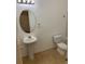 Well-lit half bathroom featuring a pedestal sink, toilet, and neutral walls at 1552 Broken Oak Dr # B, Winter Garden, FL 34787