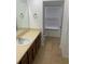Bathroom with wood cabinets, a large mirror, and neutral tile floors at 1552 Broken Oak Dr # B, Winter Garden, FL 34787