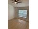 Neutral bedroom featuring wood floors, large window, and a ceiling fan at 1552 Broken Oak Dr # B, Winter Garden, FL 34787