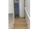 Hallway leading up stairs with natural wood flooring, white trim, and neutral walls at 1552 Broken Oak Dr # B, Winter Garden, FL 34787