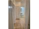Hallway featuring light wood flooring and a clear view to a bathroom, creating a serene and comforting experience at 1552 Broken Oak Dr # B, Winter Garden, FL 34787