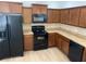 Kitchen featuring black appliances, wooden cabinetry and light countertops at 1552 Broken Oak Dr # B, Winter Garden, FL 34787