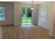 Bright living room featuring light wood floors, large windows, and sliding glass doors that lead to the backyard at 1552 Broken Oak Dr # B, Winter Garden, FL 34787