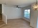 Bright living room featuring light wood floors, a modern ceiling fan, and a staircase leading to the upper level at 1552 Broken Oak Dr # B, Winter Garden, FL 34787