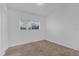 Bedroom with carpet flooring and a large window offering natural light at 1725 Marcia Dr, Orlando, FL 32807