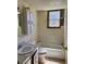 Bathroom featuring standard tub, tile walls, and storage space at 1811 S Westmoreland Dr, Orlando, FL 32805
