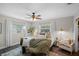 Relaxing bedroom with neutral tones, natural light, and cozy seating area for ultimate comfort at 1815 6Th Se St, Winter Haven, FL 33880