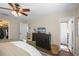 This bedroom has a ceiling fan, dark wood floors, and a wardrobe with black doors at 1815 6Th Se St, Winter Haven, FL 33880