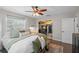 This bedroom features a large closet, hardwood floors, a ceiling fan, and a large window at 1815 6Th Se St, Winter Haven, FL 33880