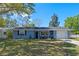 Well-maintained single-Gathering home with a lush green lawn and a cozy front porch under a clear blue sky at 1815 6Th Se St, Winter Haven, FL 33880