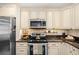 Well-equipped kitchen features stainless steel appliances and granite countertops, providing style and functionality at 1815 6Th Se St, Winter Haven, FL 33880