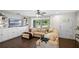 Bright living room with hardwood floors, large windows, and a comfortable sectional sofa at 1815 6Th Se St, Winter Haven, FL 33880