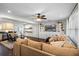 Open-concept living room with hardwood floors, and built in shelving next to a large sectional sofa at 1815 6Th Se St, Winter Haven, FL 33880