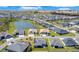 Aerial view of the neighborhood with a pond and well-maintained landscaping at 1959 Keel Ct, The Villages, FL 34762