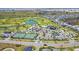 Aerial view of a golf course with lakes, tennis courts, and a clubhouse at 1959 Keel Ct, The Villages, FL 34762