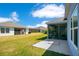 Spacious backyard with green lawn and screened-in patio, perfect for outdoor living at 1959 Keel Ct, The Villages, FL 34762
