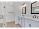 Bright bathroom featuring double sinks, modern fixtures, and a glass-enclosed shower at 1959 Keel Ct, The Villages, FL 34762