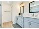 Bright bathroom with a double vanity, modern sinks, and a shower reflected in the mirror at 1959 Keel Ct, The Villages, FL 34762