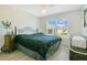 Comfortable bedroom with a large window, ceiling fan, and a wrought iron bed frame with a dark comforter at 1959 Keel Ct, The Villages, FL 34762