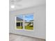 Bright bedroom with light wood floors and a large window offering neighborhood views at 1959 Keel Ct, The Villages, FL 34762