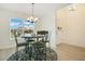 Bright dining area features views of the front yard, stylish lighting, and seamless wood flooring at 1959 Keel Ct, The Villages, FL 34762