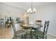 Open-concept dining area boasts views of the outdoor space and connects to a spacious living room and modern kitchen at 1959 Keel Ct, The Villages, FL 34762