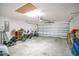 Spacious garage with an overhead door, bicycle storage, and ample room for vehicles or workshop at 1959 Keel Ct, The Villages, FL 34762