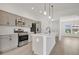 Modern kitchen with stainless steel appliances, ample cabinet space, and a center island with a sink at 1959 Keel Ct, The Villages, FL 34762