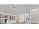 Open-concept kitchen featuring stainless steel appliances, a center island, and a view to the entry at 1959 Keel Ct, The Villages, FL 34762