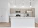 Modern kitchen featuring stainless steel appliances, pendant lighting, and a center island with a sink at 1959 Keel Ct, The Villages, FL 34762