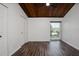 Bedroom with hardwood floors, dark wood ceiling, closet, and window letting in natural light at 200 Maitland Ave # 86, Altamonte Springs, FL 32701