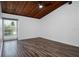 Bedroom with hardwood floors and dark wood ceiling with window letting in natural light at 200 Maitland Ave # 86, Altamonte Springs, FL 32701