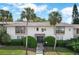 Condo building featuring palm trees, manicured shrubs, and well-maintained landscaping at 200 Maitland Ave # 86, Altamonte Springs, FL 32701